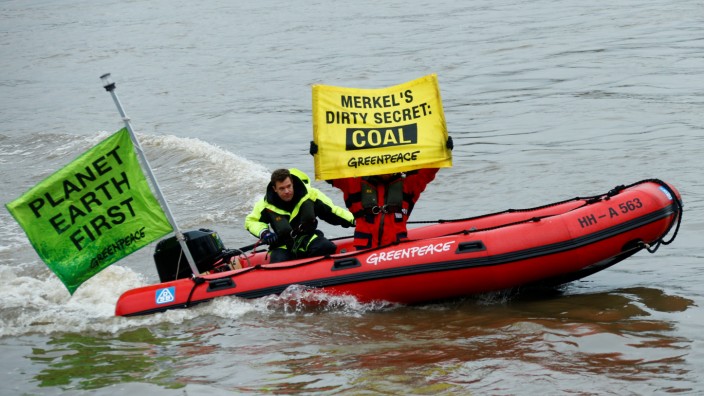 A boat with activists is seen in front of a coal transport ship as a part of a protest organised on the river Rhein by the environmental organisation Greenpeace during COP23 U.N. Climate Change Conference in Bonn