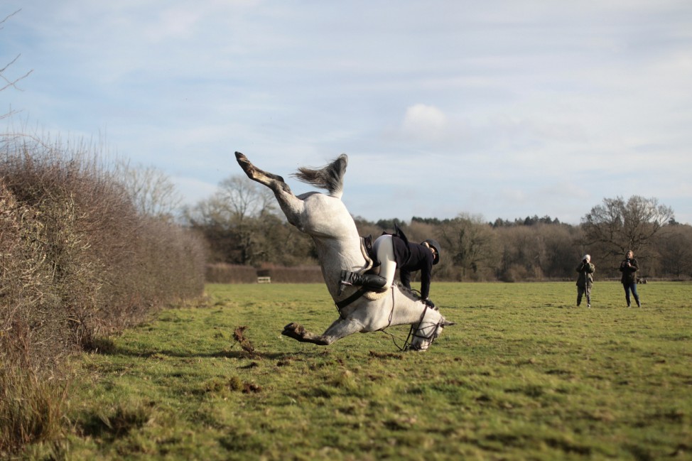A member of the Old Surrey Burstow and West Kent Hunt crashes as she jumps a fence during the annual Boxing Day hunt in Chiddingstone