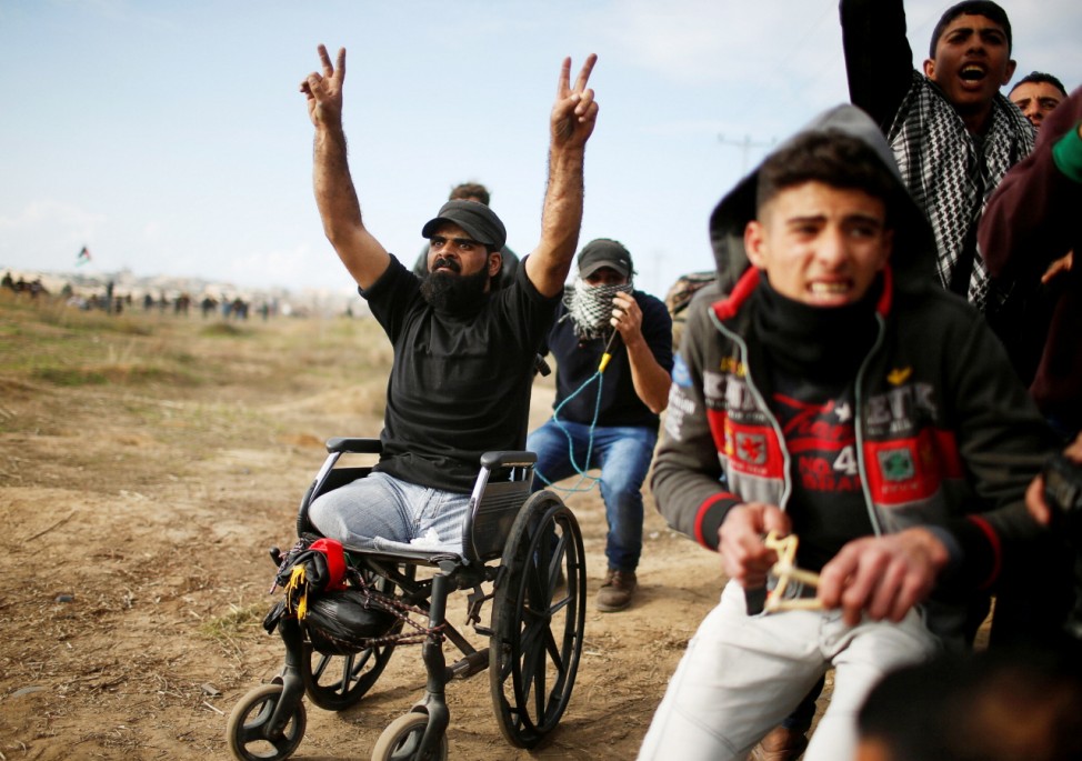 Wheelchair-bound Palestinian demonstrator Ibraheem Abu Thuraya, who according to medics was killed later on Friday during clashes with Israeli troops, gestures during a protest, near the border with Israel in the east of Gaza City