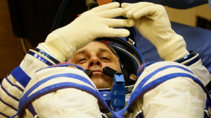 ISS crew member Anton Shkaplerov of Russia looks on during his space suit check shortly before his launch at the Baikonur Cosmodrome