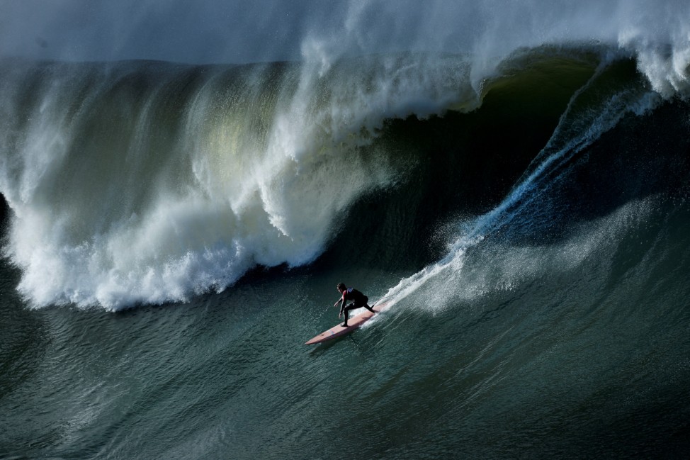 A surfer rides a wave during the Punta Galea Big Wave Challenge in Punta Galea, near Bilbao
