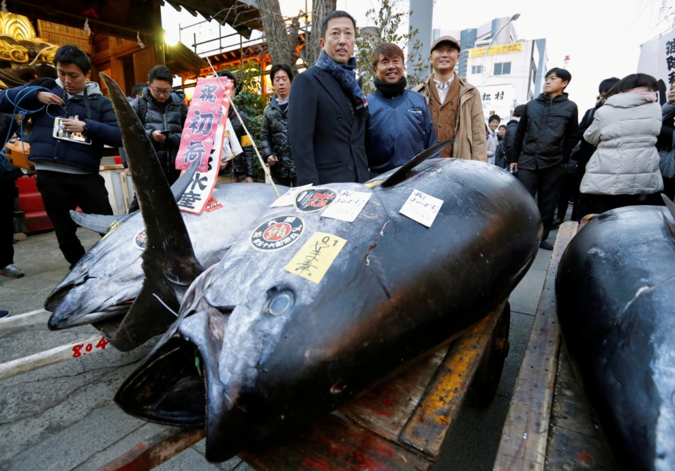 LEOC Co's Chairman, CEO and President Onodera, who runs a chain of sushi restaurants, poses with a 405 kg bluefin tuna outside Tsukiji fish market in Tokyo