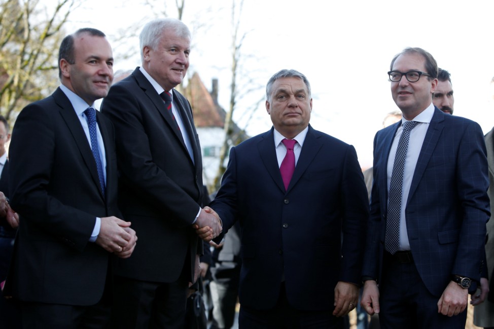 Outgoing Bavarian state premier and leader of the Christian Social Union (CSU) Horst Seehofer shakes hands with Hungarian Prime Minister Victor Orban as they attend a CSU party meeting at 'Kloster Seeon' in Seeon