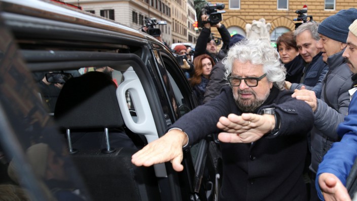 5-Star Movement member Beppe Grillo leaves after presenting the symbol of his party, that will run in the country's March 4 election, in Rome