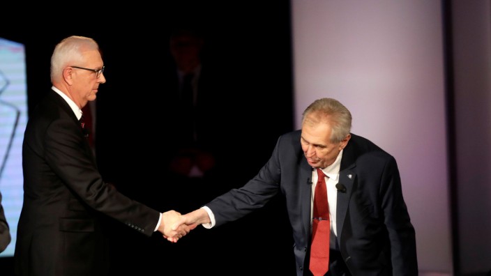 Czech presidential candidate Jiri Drahos and incumbent Milos Zeman shake hands after a televised debate ahead of an election run-off, in Prague