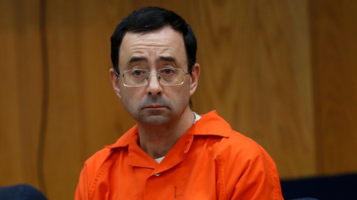 Larry Nassar, a former team USA Gymnastics doctor who pleaded guilty to sexual assault, listens to victims impact statements during his sentencing in the Eaton County Circuit Court in Charlotte