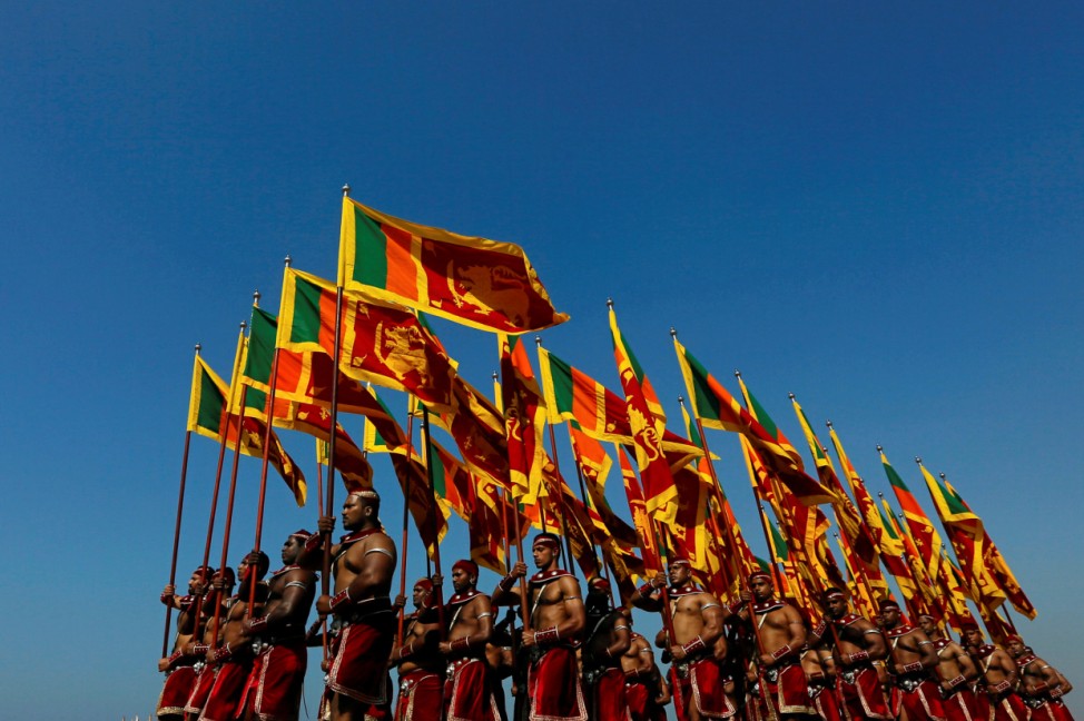 Sri Lanka's military members march with the national flags at the parade during a rehearsal for Sri Lanka's 70th Independence day celebrations in Colombo