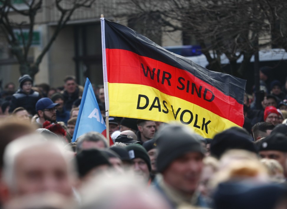 People attend a demonstration against migrants in Cottbus