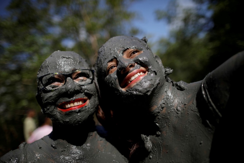 Members of the 'Bloco Pretinhos do Mangue' (Block of Blackheads from Mud) group perform during carnival festivities in Curuca