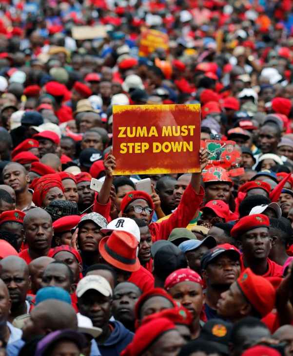 Protesters hold placards as they gather in South Africa's capital to protest against President Jacob Zuma in Pretoria