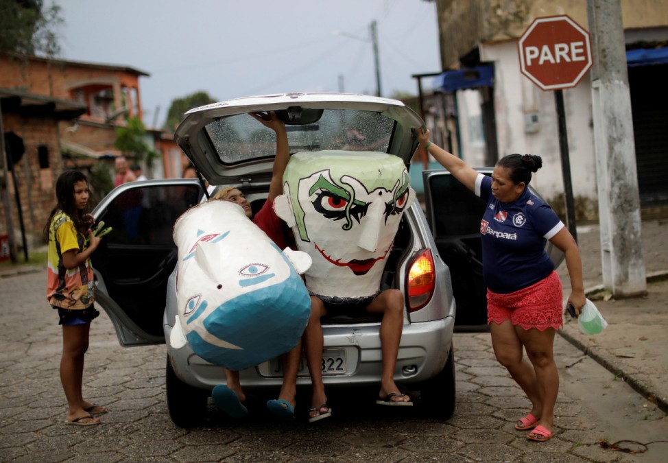 Members of the 'Group Boi Faceiro' arrive at carnival festivities in Sao Caetano de Odivelas