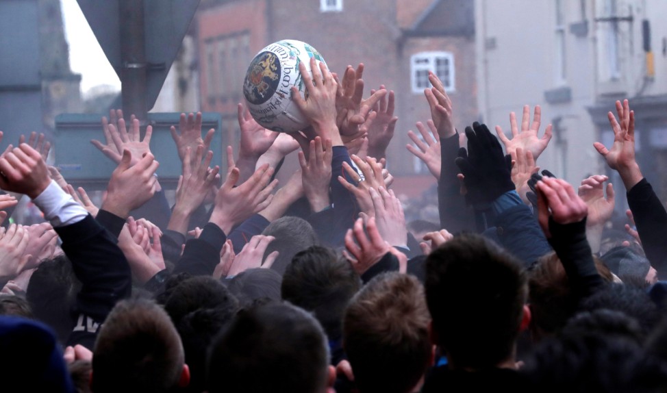 Players scrabble for the ball during the annual Ashbourne Royal Shrovetide Football match in Ashbourne