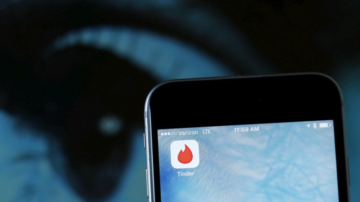 FILE PHOTO: Photo illustration of dating app Tinder shown on an Apple iPhone