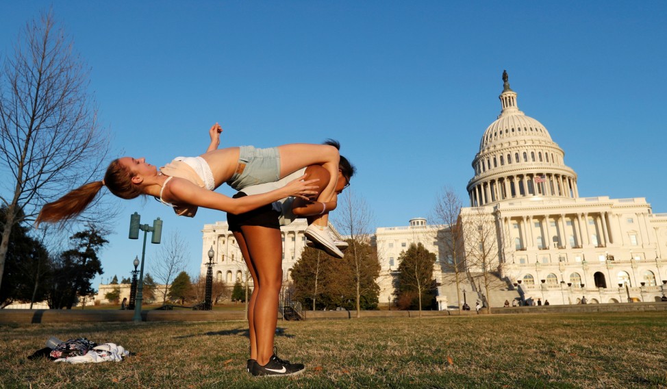 Friends enjoy a record setting warm winter day at the U.S. Capitol in Washington