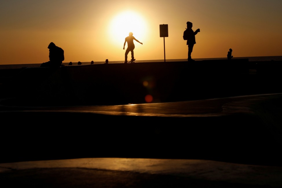 A skateboarder is seen in silhouette on Venice Beach in Los Angeles