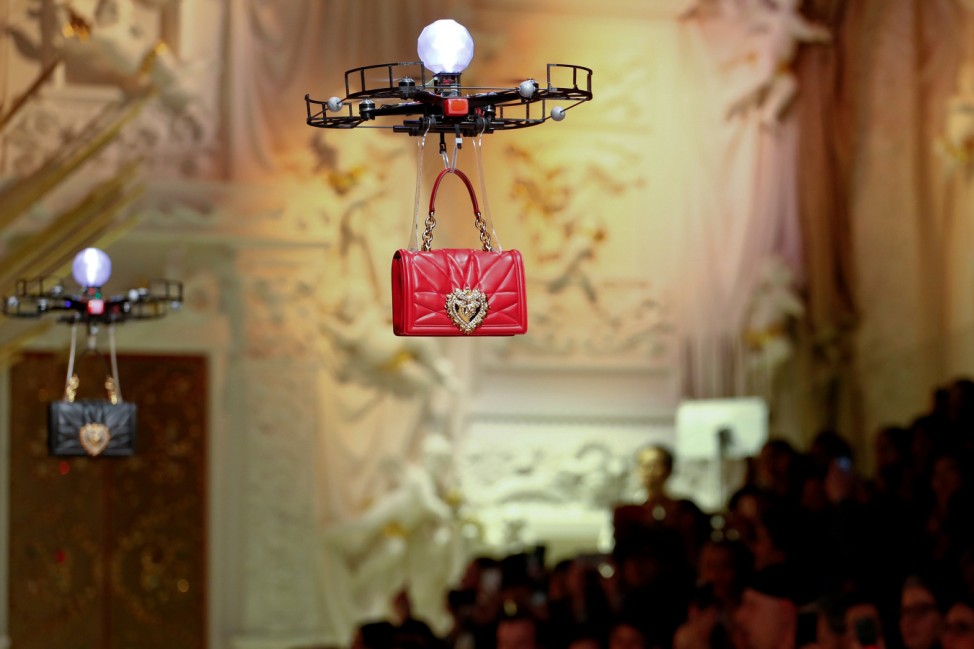 Drones carry bags, the creations from the Dolce & Gabbana Autumn/Winter 2018 women's collection during Milan Fashion Week in Milan