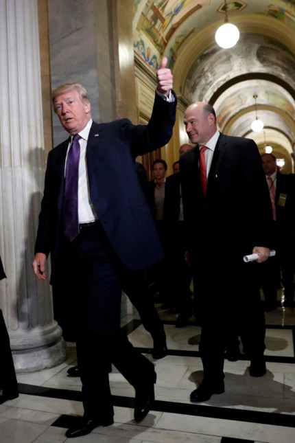 FILE PHOTO:    U.S. President Donald Trump arrives with Director of the National Economic Council Gary Cohn at the U.S. Capitol to meet with House Republicans ahead of their vote on the 'Tax Cuts and Jobs Act' in Washington