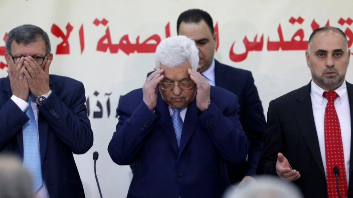 Palestinian President Mahmoud Abbas reads the Koran at the start of Fatah Revolutionary Council meeting in Ramallah, in the occupied West Bank