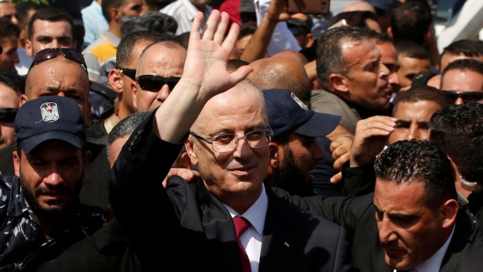 FILE PHOTO: Palestinian Prime Minister Rami Hamdallah waves upon his arrival, in the northern Gaza Strip