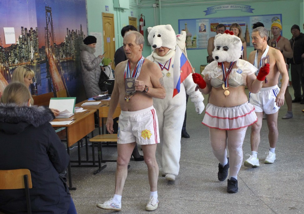 Members of a local winter swimming club visit a polling station during the presidential election in Barnaul