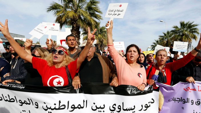 Protesters shout slogans during a march, demanding equal inheritance rights for women, in Tunis