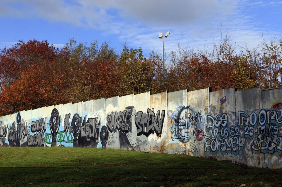 A section of the peace wall that divides Catholic and Protestant communities runs through the middle of Alexandra Park in north Belfast