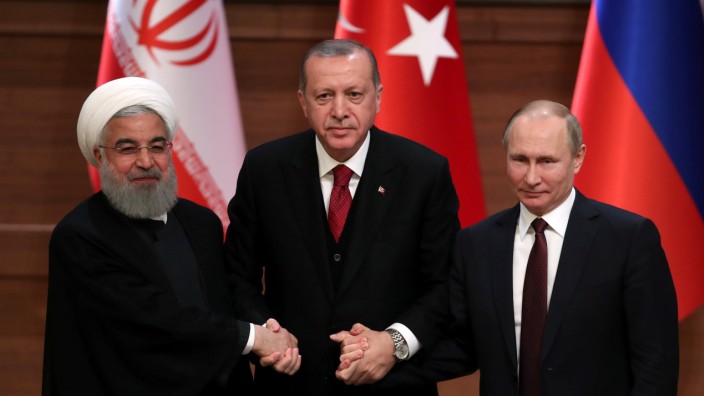 Presidents Rouhani of Iran, Erdogan of Turkey and Putin of Russia hold a joint news conference after their meeting in Ankara