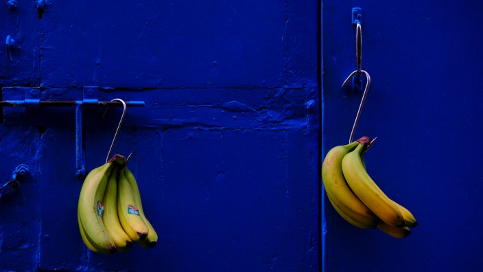 Bunches bananas hang on the door of  'All Season', a greengrocer's shop in Valletta