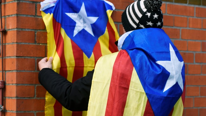 A supporter of former Catalan regional president Carles Puigdemont fixes an Estelada at the prison in Neumuenster