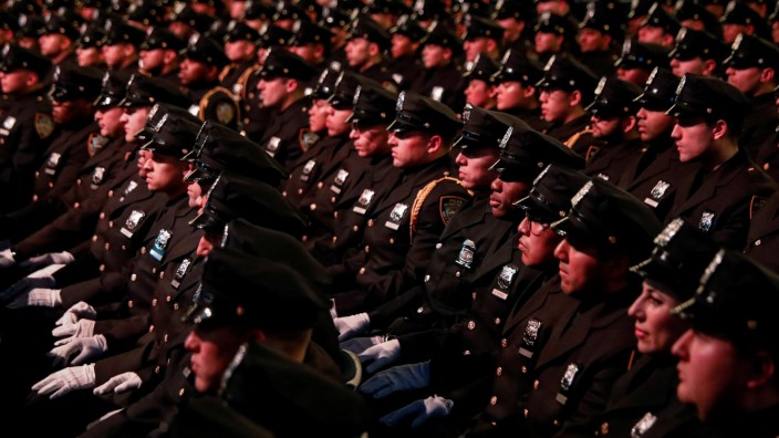 New York City Police (NYPD) officers sit during their graduation ceremony at Madison Square Garden in New York