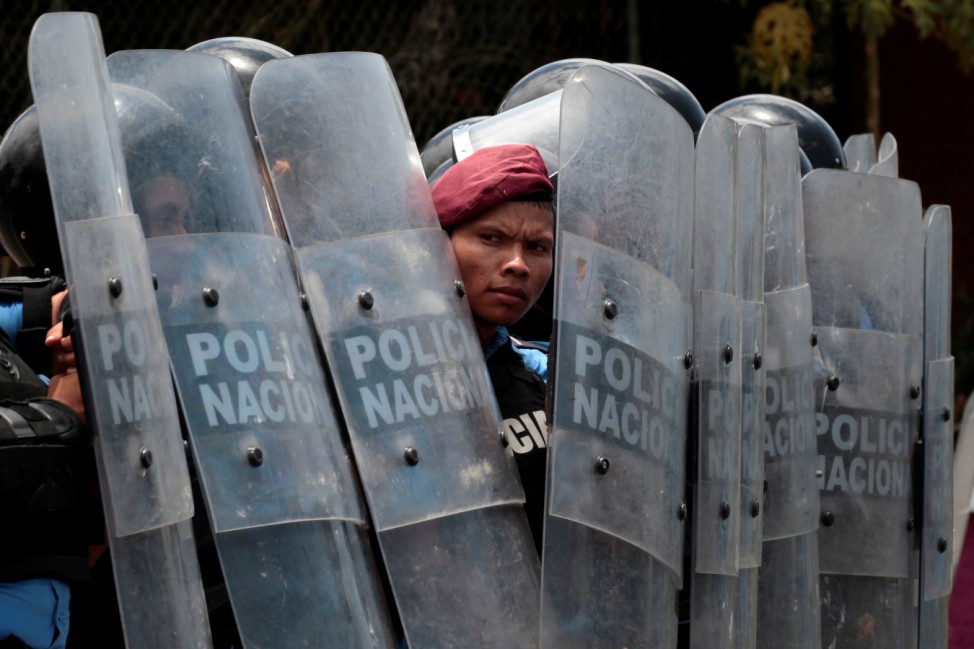 A riot policeman looks on during clashes with university students protesting over a controversial reform to the pension plans of the Nicaraguan Social Security Institute in Managua