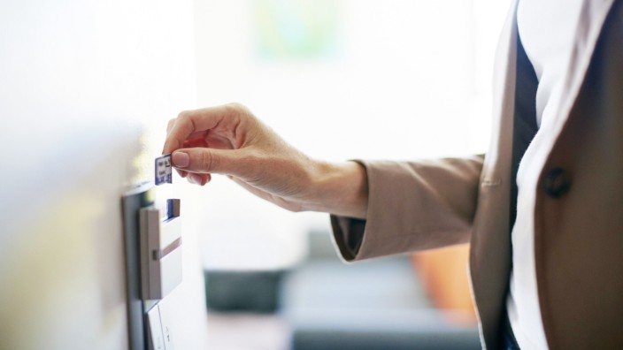 Woman using electronic keycard on hotel room door model released Symbolfoto property released PUBLIC