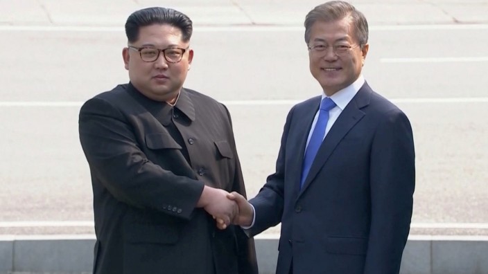 North Korean leader Kim Jong Un shakes hands with South Korean President Moon Jae-in as both of them arrive for the inter-Korean summit at the truce village of Panmunjom, in this still frame taken from video