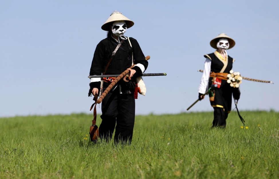 People dressed as characters from the computer game 'World of Warcraft' walk across a field near the town of Kamyk nad Vltavou