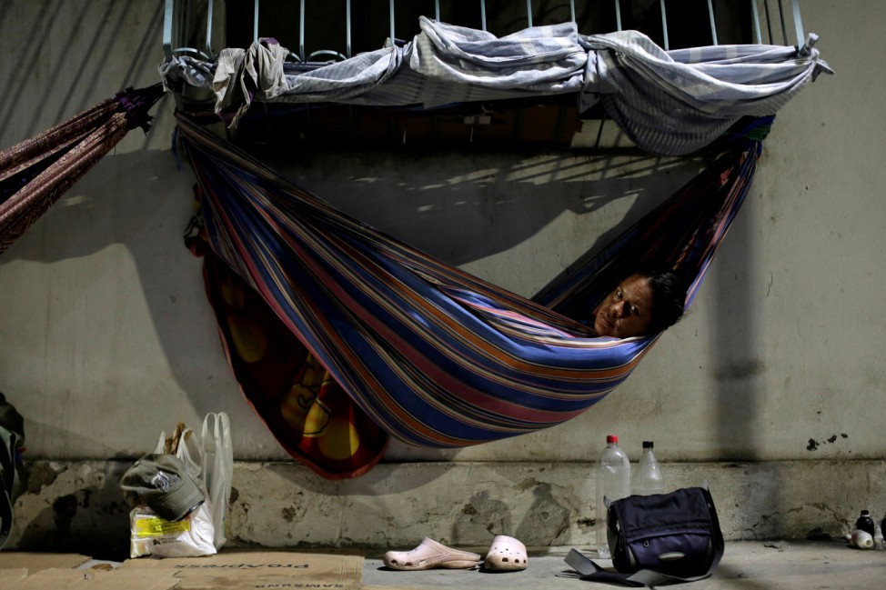 Venezuelan refugee Gabriela Martinez, who worked as a telecommunications engineer, relaxes in a hammock near a bus station in Manaus, Brazil