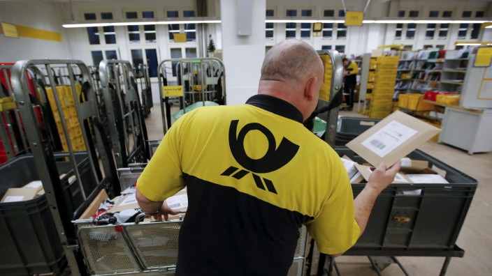 File photo of a postman of Deutsche Post sorting mail at a sorting office in Berlin
