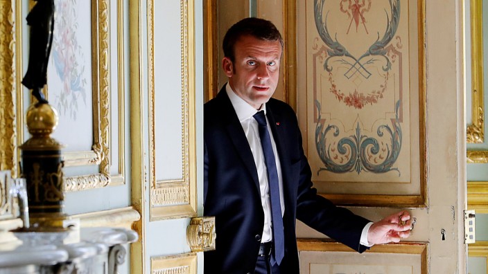 French President Emmanuel Macron walks out of his office at the Elysee Palace in Paris
