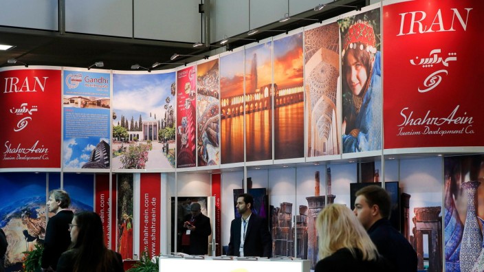 Visitors browse exhibition stand of Iran at the International Tourism Trade Fair in Berlin