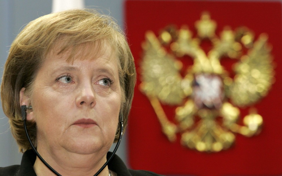 German Chancellor Merkel is seen beside the national coat of arms during a news conference with Russia's President Putin near Sochi