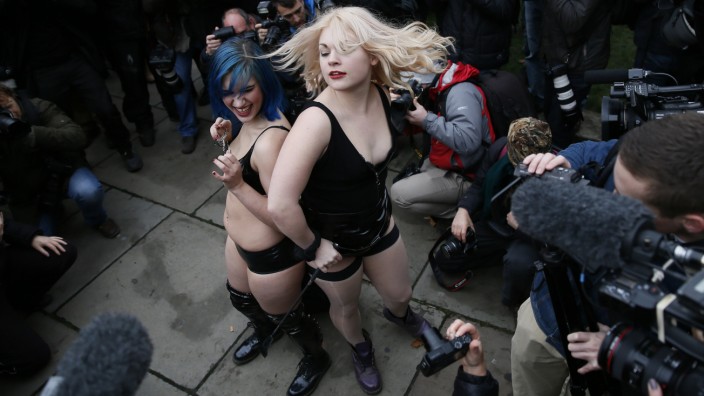 Protesters take part in a demonstration against new laws on pornography outside parliament in central London