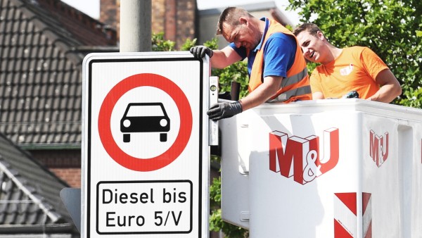 FILE PHOTO: Traffic signs which ban diesel cars are installed by workers at the Max-Brauer Allee in downtown Hamburg