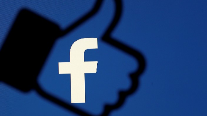 FILE PHOTO: A 3D-printed Facebook like button is seen in front of the Facebook logo, in this illustration