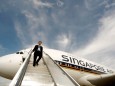 FILE PHOTO: Singapore Airlines staff member walks down a set of stairs from an Airbus A380 in Sydney