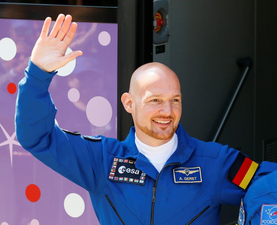 The International Space Station (ISS) crew member Alexander Gerst of Germany waves in front of a bus before leaving for a pre-launch preparation at the Baikonur Cosmodrome