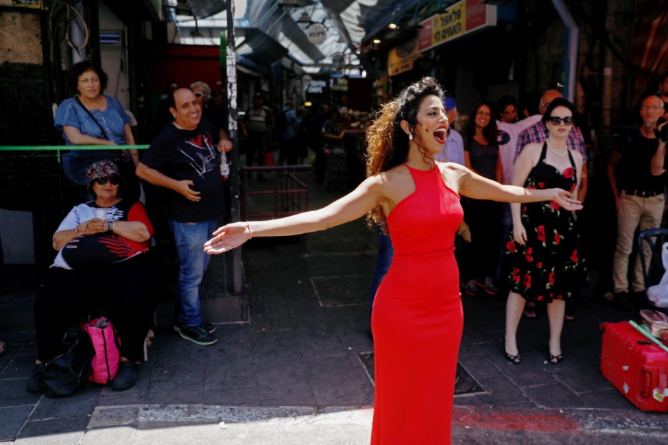A soloist from the Israeli Opera sings during an open rehearsal of Giacomo Puccini's 'Madama Butterfly' at the Mahane Yehuda market in Jerusalem, ahead of the Israel Festival