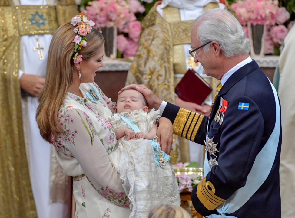 Princess Madeleine and king Carl Gustaf are seen during princess Adrienne's christening ceremony  in Drottningholm Palace Chapel outside Stockholm