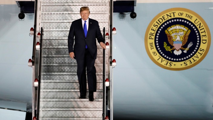 U.S. President Donald Trump steps off his plane as he arrives at Paya Lebar Air Base in Singapore