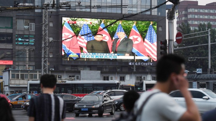 Vereinbarung von Trump und Kim: Auf einem großen Bildschirm in Peking werden Szenen des Gipfeltreffens in Singapur übertragen.