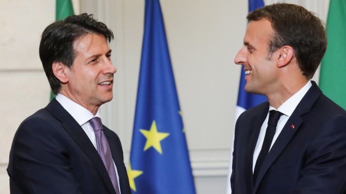 French President Emmanuel Macron and Italian Prime Minister Giuseppe Conte shake hands at the end of a joint news conference at the Elysee Palace in Paris