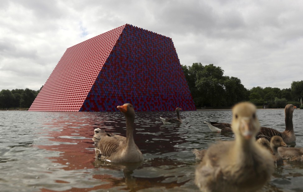 Ducks and ducklings paddle in front of Christo's work The London Mastaba, on the Serpentine in Hyde Park, London